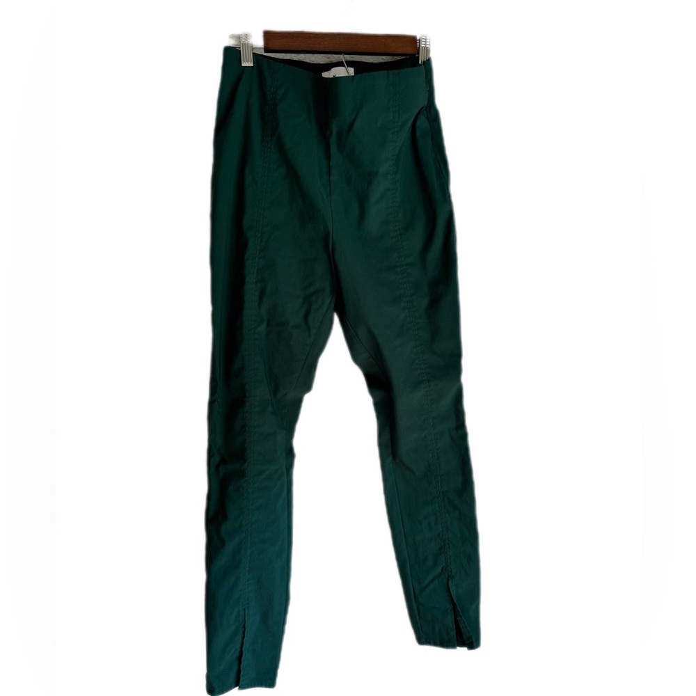 Green skinny pants with side zipper closure and split front detail